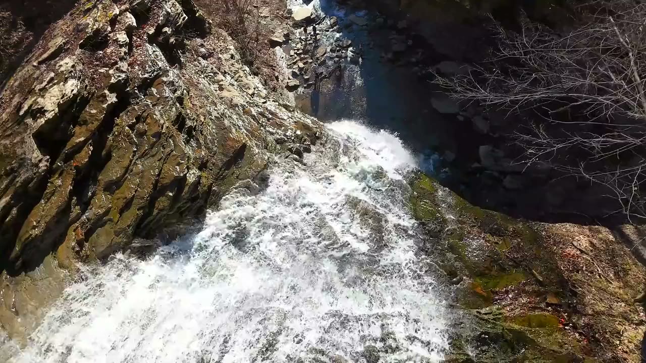 Dramatic drone shots of waterfalls in a rugged river gorge, filmed by Horizon Heights Productions.